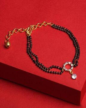 gold-plated stone-studded adjustable bracelet