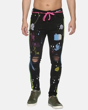 graphic print lightly distress tapered jeans