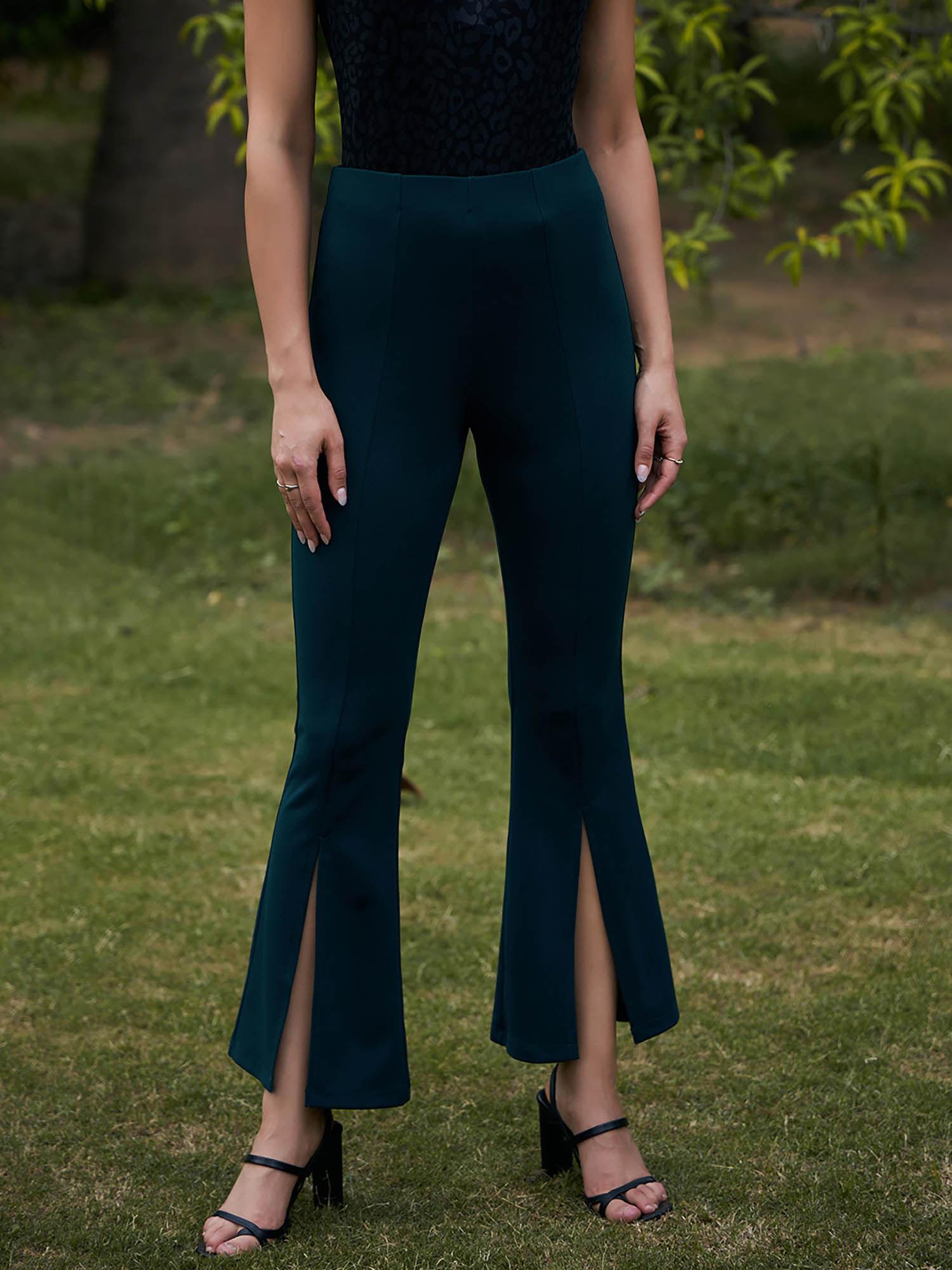 green high-rise bootcut trousers with front slits