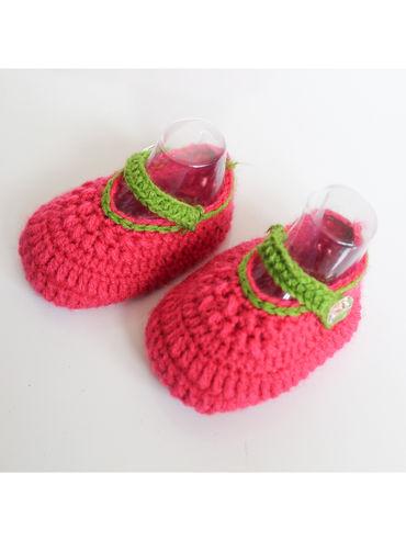 handmade pink and green woolen bootieswith button closure