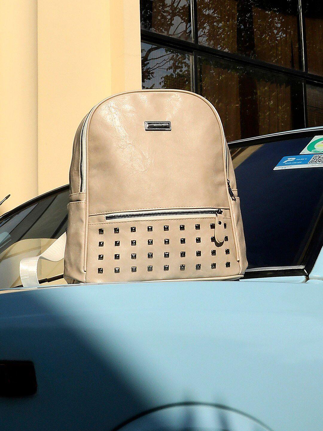 haute sauce by campus sutra women peach-coloured & steel embellished backpack with compression straps