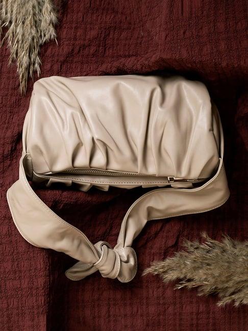 hautesauce beige medium duffel bag with a knotted strap
