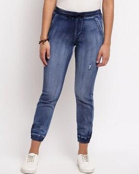 heavily washed distressed relaxed fit jeans