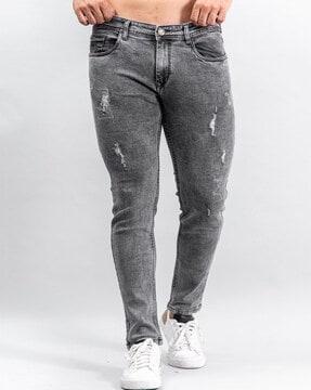 heavily washed distressed relaxed fit jeans