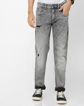 heavily washed slim fit distressed jeans