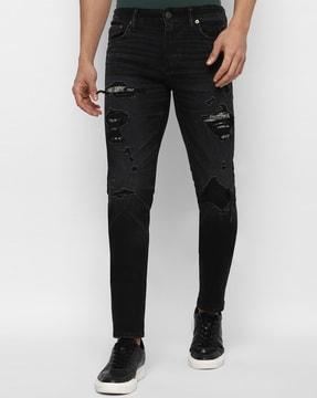 heavily washed slim-fit jeans