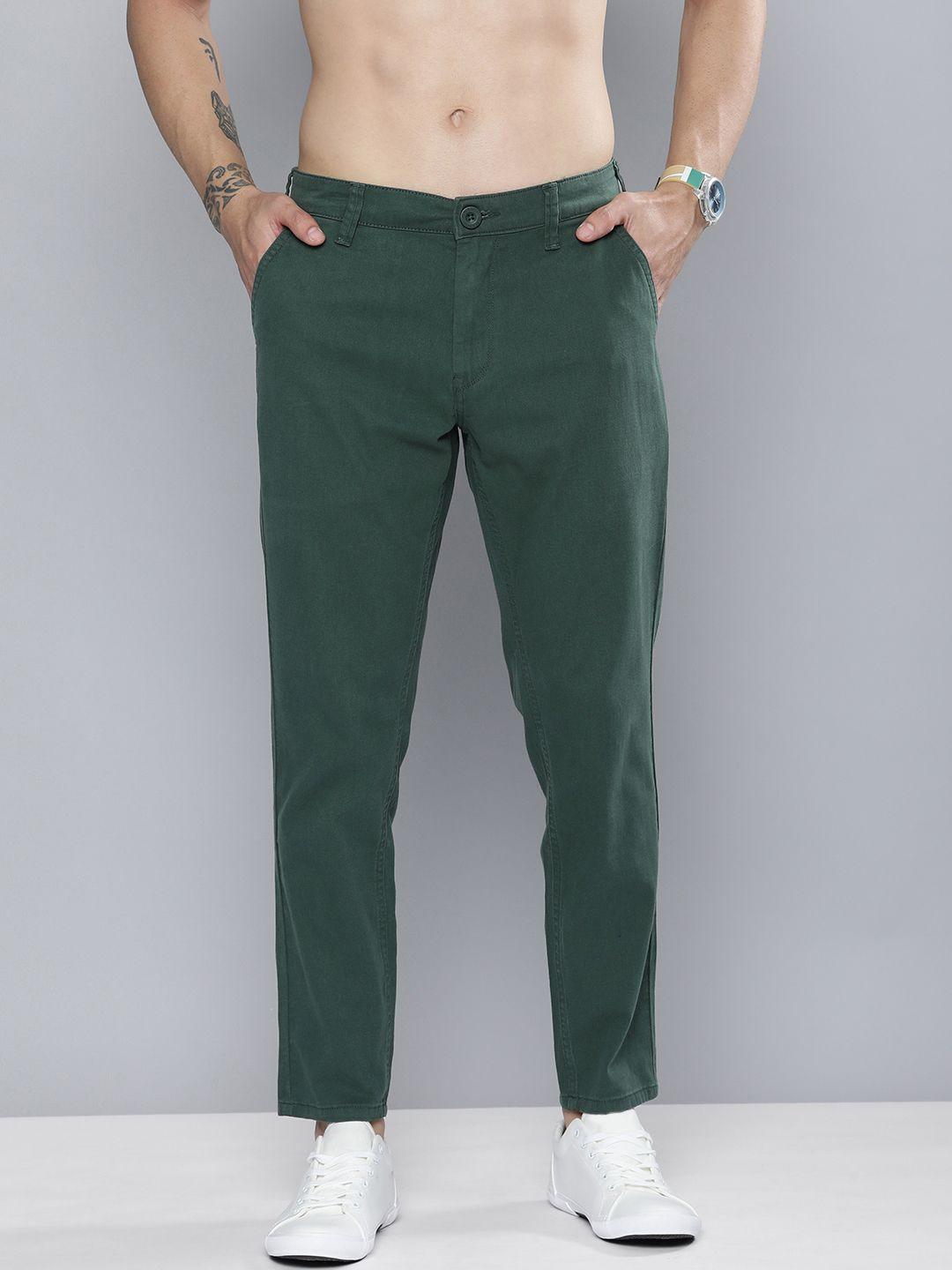 here&now men dark green solid slim fit mid-rise regular trousers