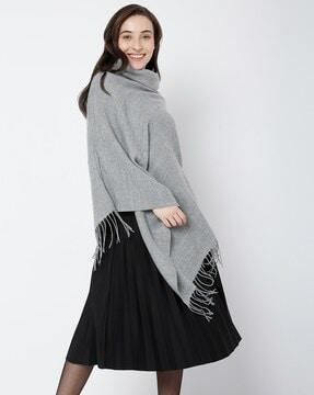 high-neck poncho with tassels