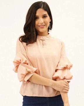 high-neck top with bell sleeves