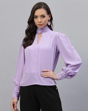 high-neck top with cuffed sleeves