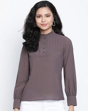 high-neck top with cuffed sleeves