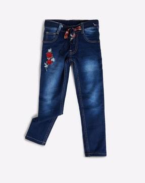 high-rise mid-wash jeans with floral embroidery