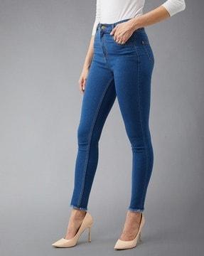 high-rise skinny jeans with fringed cuffs