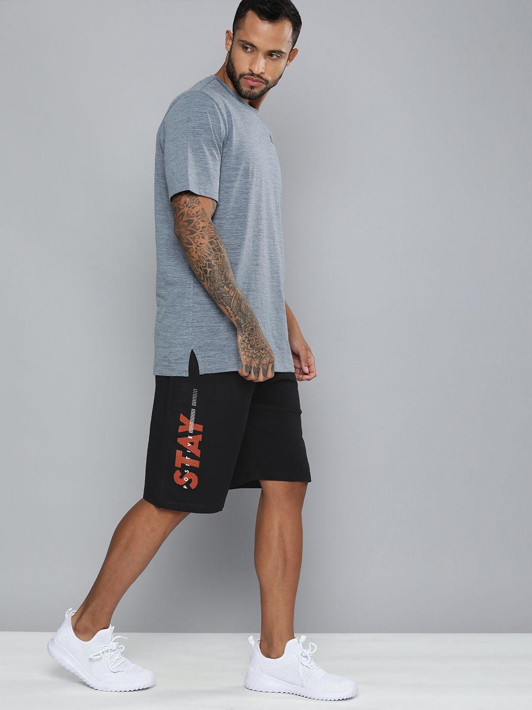 hrx by hrithik roshan men black & orange typography printed shorts