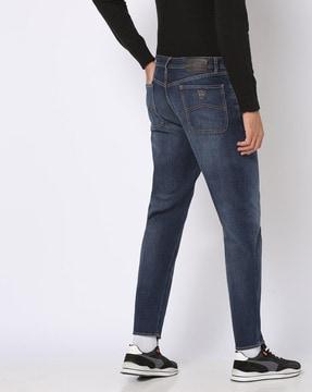 j90 mid-wash carrot fit jeans