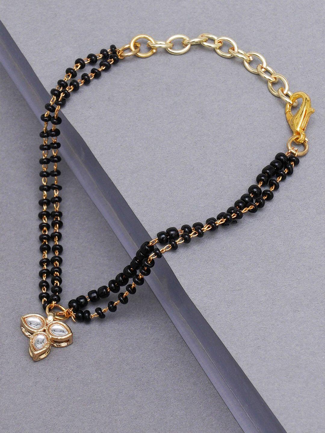 karatcart women gold-toned & black kundan gold-plated charm bracelet