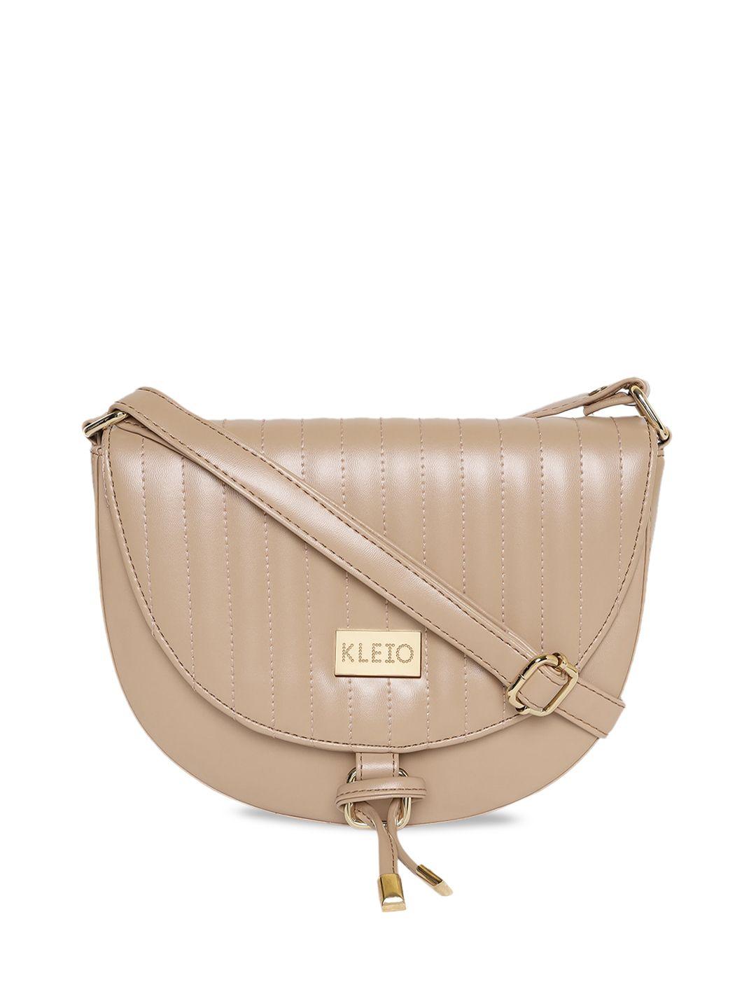 kleio quilted half moon sling bag with tasseled detail