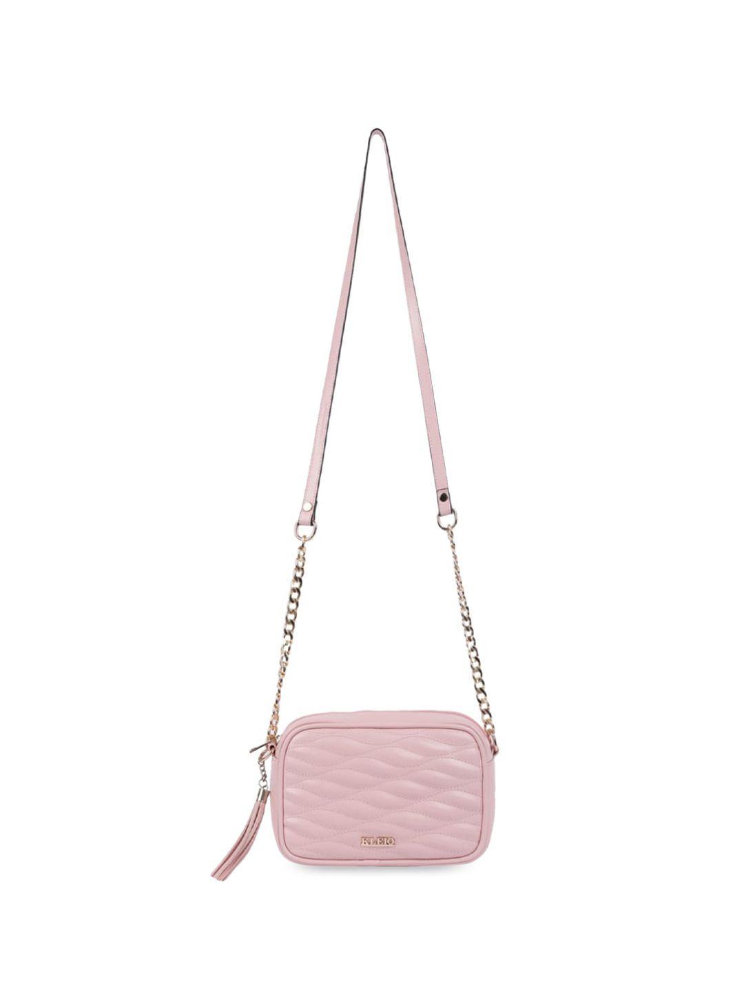 kleio textured structured sling bag with tasselled