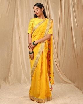 lace border saree with pom poms