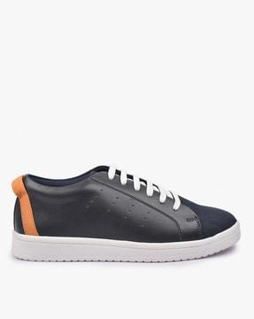 lace-up sports shoes with perforated panels