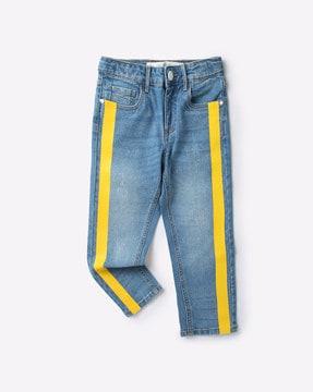 light-wash distressed jeans with contrast stripes