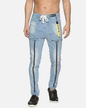 light-wash tapered jeans with zip accent