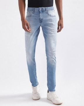 light-washed tapered distressed jeans