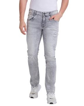 lightly washed tapered distressed jeans