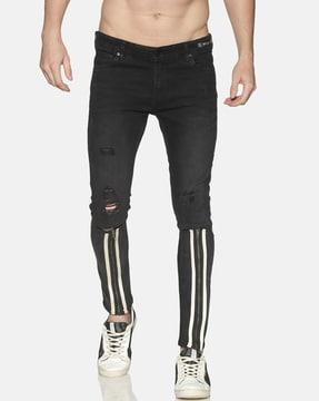 lightly distress tapered jeans with zip accent