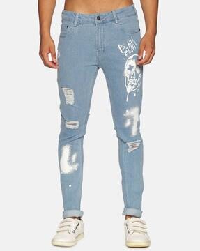 lightly washed distressed tapered jeans