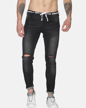 lightly washed distressed tapered jeans