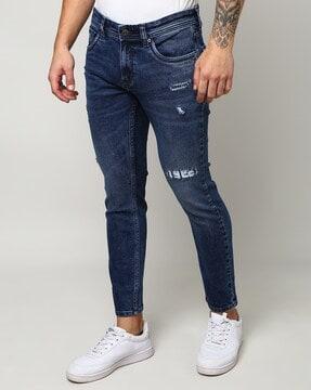 lightly-washed skinny fit distressed jeans