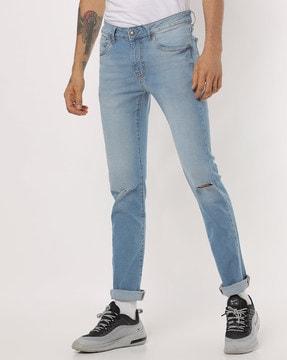 lightly washed skinny fit jeans with distressing