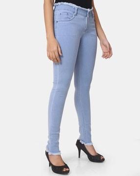 lightly-washed skinny jeans with frayed hems