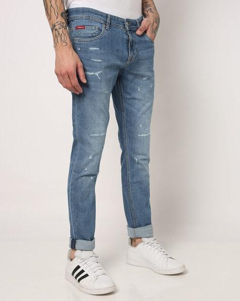 lightly washed slim fit distressed jeans