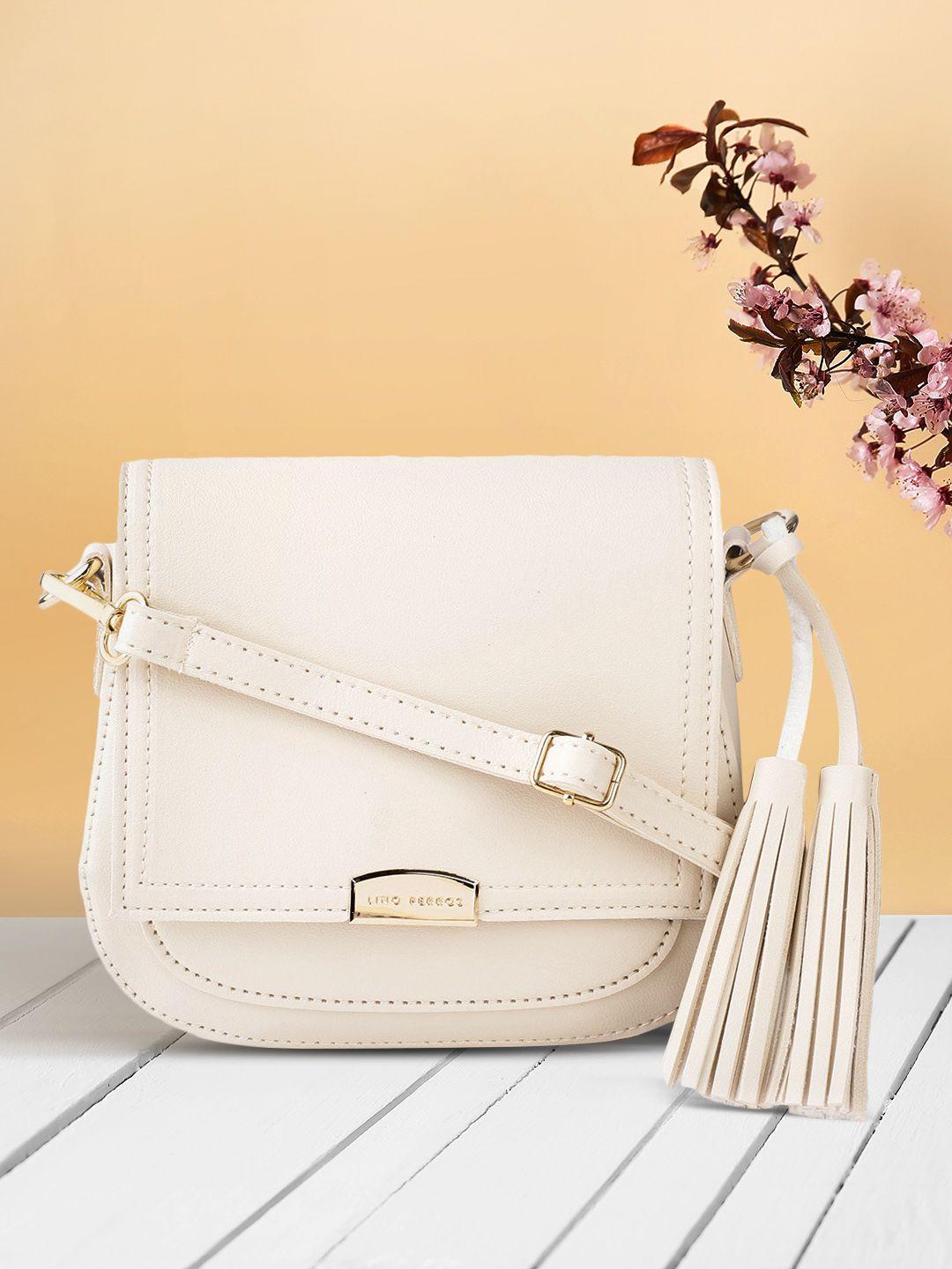 lino perros women cream-coloured solid sling bag with tasselled detail