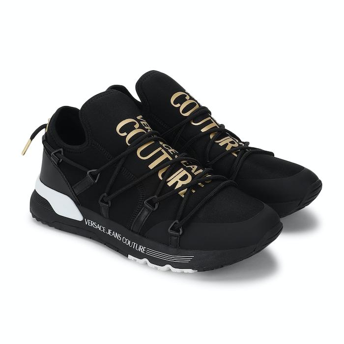 men black trainers with golden branding on tongue