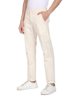 men cream mid rise solid casual trousers