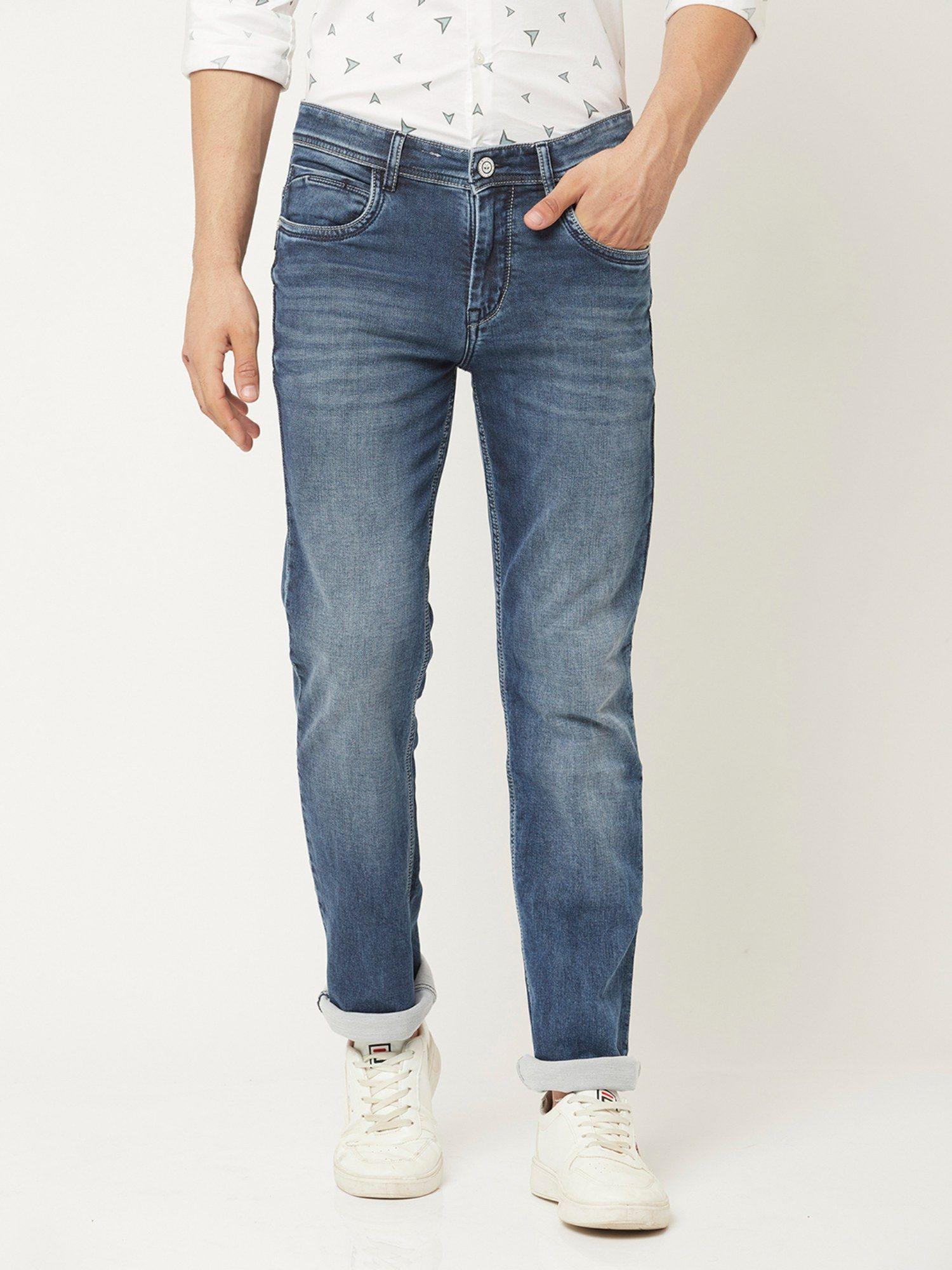 men light wash jeans with leather logo patch