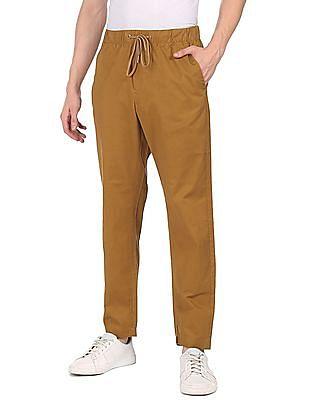 men mustard mid rise drawstring waist solid casual trousers