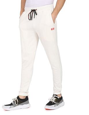 men off white mid rise elasticised waist solid joggers