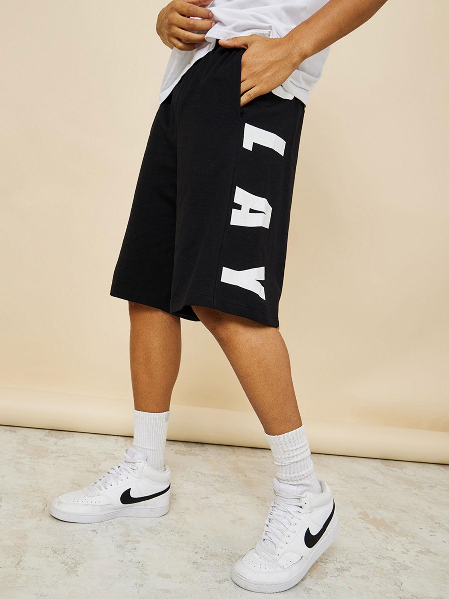 mens black cotton oversized terry shorts with bold text print detail