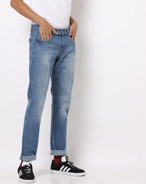 mid-rise slim fit washed jeans with whiskers