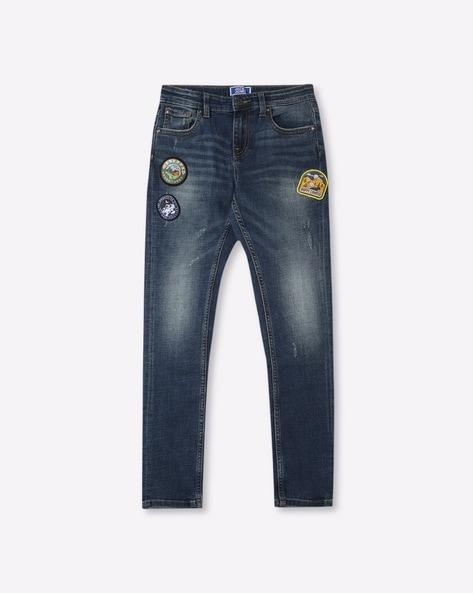 mid-wash distressed jeans with appliques