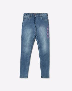 mid-wash jeans with typographic print