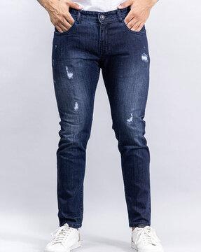 mid wash heavy distress slim jeans