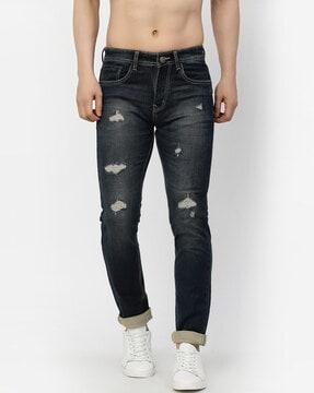 mid-wash slim jeans with distress