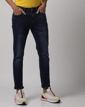 mid-wash slim tapered fit jeans with whiskers