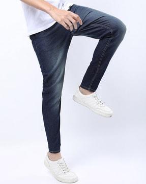 mid-wash tapered fit jeans with insert pockets