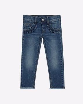 mid-washed jeans with frayed hems